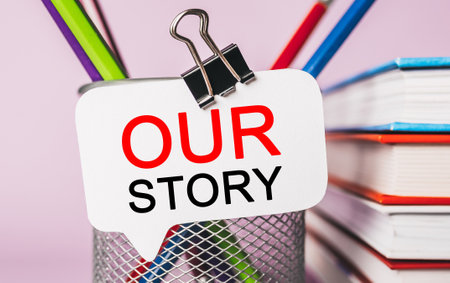 Text Our Story on a white sticker with office stationery background. Flat lay on business, finance and development conceptの写真素材