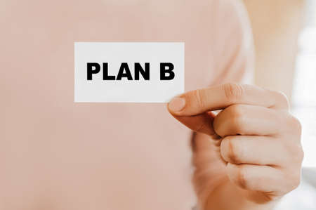 Man holding a business card with PLAN Bの写真素材