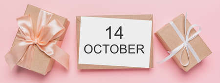 Gifts with note letter on isolated pink background, love and valentine concept with text 14 Octoberの写真素材