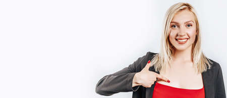 Beautiful young girl pointing with fingers on gray isolated backgroundの写真素材