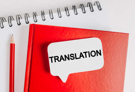 Text TRANSLATION on a white sticker with office stationery background. Flat lay on business, finance and development conceptの写真素材