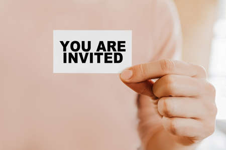 Man holding a business card with You Are Invitedの写真素材