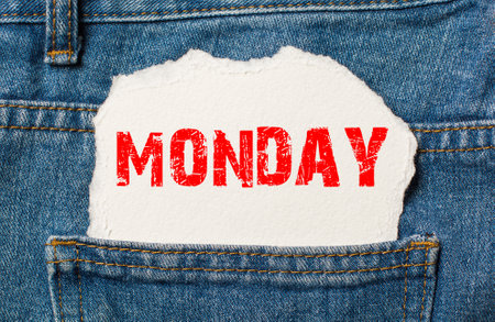 Monday on white paper in the pocket of blue denim jeansの写真素材