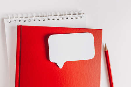 Red notepad and white sticker on the desk. Mock up in copy space office background. It is important not to forget the noteの写真素材