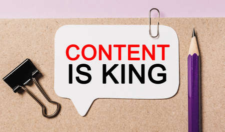 Text Content is King on a white sticker with office stationery background. Flat lay on business, finance and development conceptの写真素材