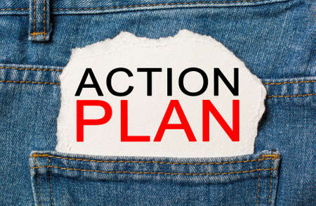 ACTION PLAN on torn paper background on jeans business and finance conceptの写真素材