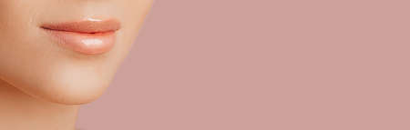 Female lips. Beautiful sensual young girl with clean skin. Woman close-up shot. The concept of spa treatments, natural beauty and care, youth, cream and mask, freshnessの写真素材