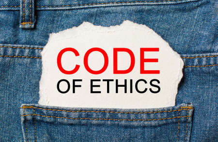 Code of Ethics on torn paper background on jeans business and finance conceptの写真素材
