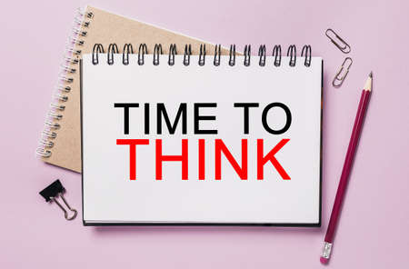 Text TIME TO THINK on a white sticker with office stationery background. Flat lay on business, finance and development conceptの写真素材