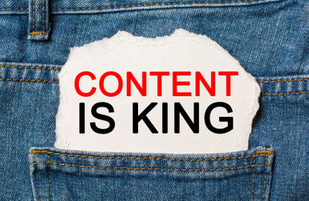 Content is King on torn paper background on jeans business and finance conceptの写真素材