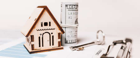 House miniature model and money on documents. Investment, real estate, home, housingの写真素材