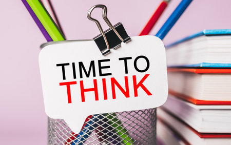 Text TIME TO THINK on a white sticker with office stationery background. Flat lay on business, finance and development conceptの写真素材