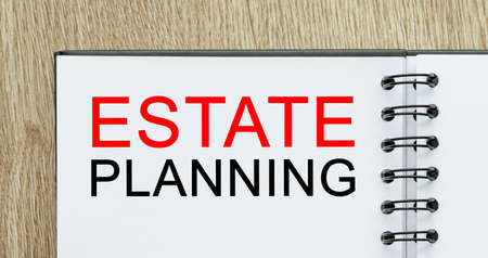 Notepad with text Estate Planning on wooden deskt. Business and finance conceptの写真素材