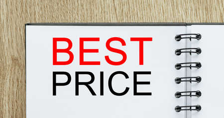 Notepad with text BEST PRICE on wooden deskt. Business and finance conceptの写真素材