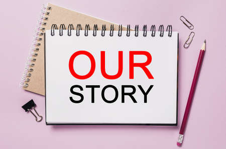 Text Our Story on a white sticker with office stationery background. Flat lay on business, finance and development conceptの写真素材