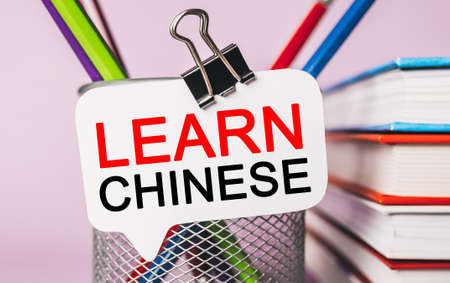 Text Learn Chinese on a white sticker with office stationery background. Flat lay on business, finance and development conceptの写真素材