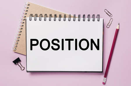 Text POSITION on a white sticker with office stationery background. Flat lay on business, finance and development conceptの写真素材