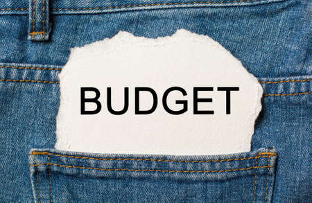 Budget on torn paper background on jeans business and finance conceptの写真素材