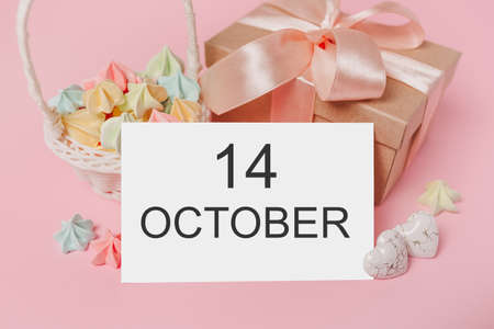 Gifts with note letter on isolated pink background with sweets, love and valentine concept with text 14 Octoberの写真素材