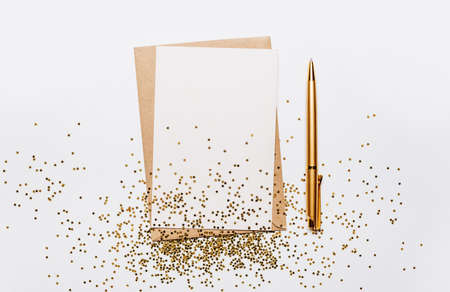 Blank note with envelope, pen and gold glitter stars on white backgroundの写真素材