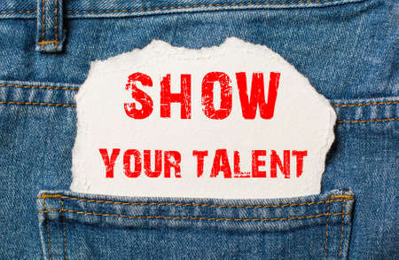 SHOW YOUR TALENT on white paper in the pocket of blue denim jeansの写真素材