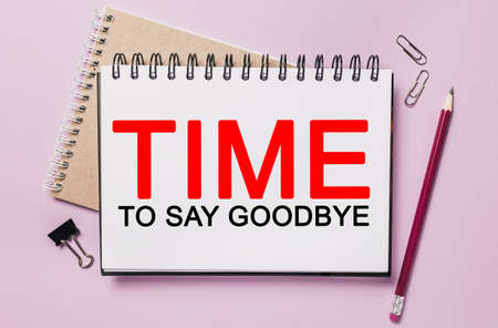 Text Time to Say Goodbye on a white sticker with office stationery background. Flat lay on business, finance and development conceptの写真素材