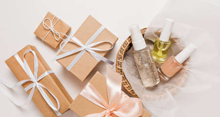 Organic cosmetics and gifts for the holiday. Flat lay, top view clear glass pump bottle, brush jar,...
