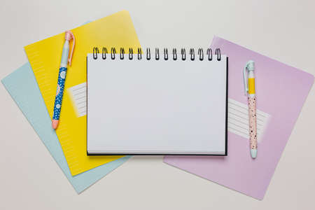 Notepad, exercise book and pen on the desk. Mock up in copy space office on white background. Back to schoolの写真素材