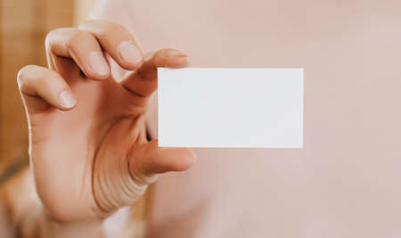 Man holding a business card with blank backgroundの写真素材