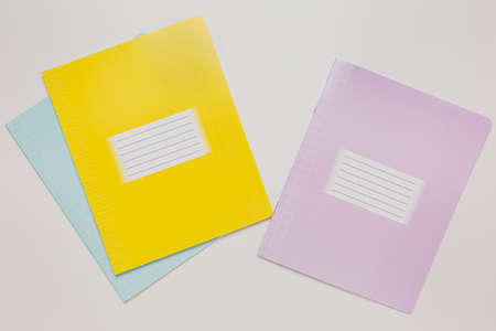 Notepad and exercise book on the desk. Mock up in copy space office on white background. Back to schoolの写真素材