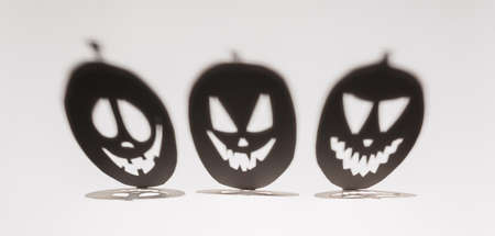 Halloween background concept. Jack O pumpkin angry face shadow. Spooky smiling shadow of an orange pumpkin lantern top view close up, Halloween party designの写真素材