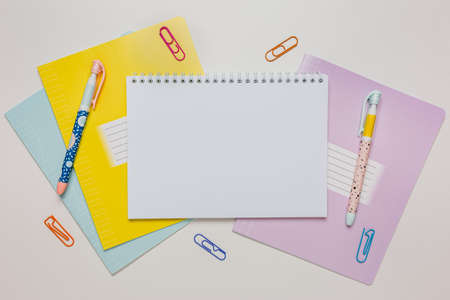 Notepad, exercise book and pen on the desk. Mock up in copy space office on white background. Back to schoolの写真素材