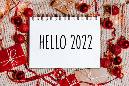 Merry christmas and merry new year concept with gift boxes and greeting card with text Hello 2022の写真素材