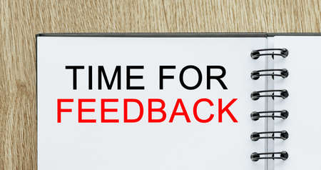 Notepad with text Time for Feedback on wooden deskt. Business and finance conceptの写真素材