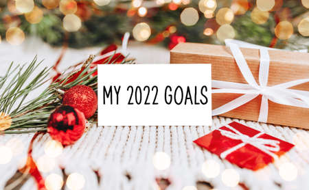 Merry christmas and merry new year concept with gift boxes and greeting card with text my 2022 goalsの写真素材