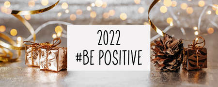 2022 be positive note with envelope, gifts and gold ribbon on white backgroundの写真素材