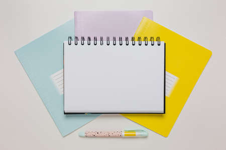 Notepad, exercise book and pen on the desk. Mock up in copy space office on white background. Back to schoolの写真素材