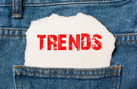 Trends on white paper in the pocket of blue denim jeansの写真素材