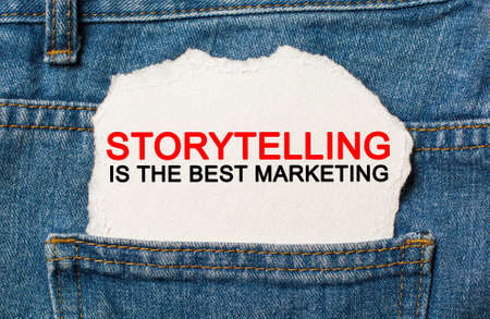 Storytelling is the best marketing on torn paper background on jeans business and finance conceptの写真素材