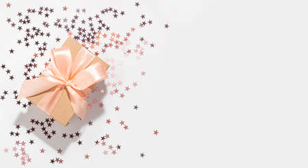 Gift with purple star shape glitter on white background with mockup. Flat lay style for holiday, birthday, wedding, new year, christmas, party, celebration conceptの写真素材
