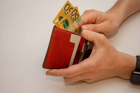 Hands holding wallet with australian dollars and counting money - coronavirus finance struggle conceptの写真素材