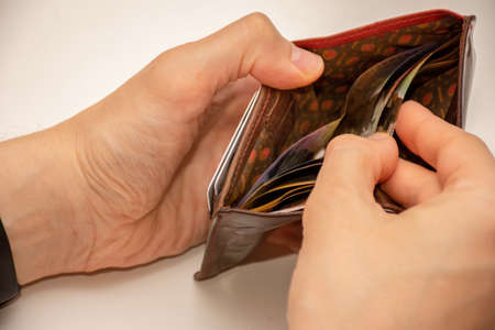 Hands holding wallet with australian dollars - low income due to coronavirusの写真素材
