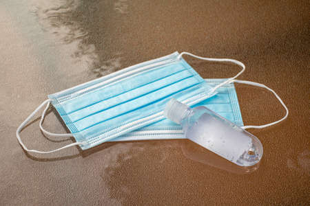 Disposable mask and hand sanitizer to prevent viruses spreading and protect yourself from influenza
