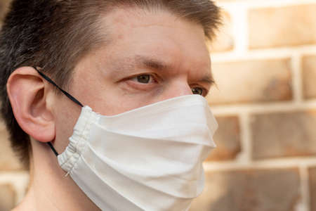 A man wearing handmade cotton face mask to prevent spreading of the viruses. Coronavirus and COVID-19 Conceptの写真素材