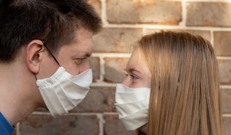 A girl and a man wearing handmade cotton face mask to prevent spreading of the viruses. Coronavirus and COVID-19 Conceptの写真素材