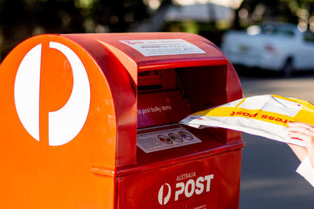 Sydney, Australia 2020-04-25 Sending an express post satchel via Australia post red post box. Australia Post experiencing significant delivery delays due to Covid-19 pandemicのeditorial素材