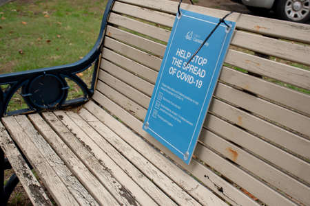 Sydney, Australia 2020-05-24 Help stop the spread of COVID-19. Health orders sign on a bench in a public park in NSW, Australia during the pandemic.のeditorial素材