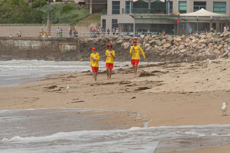 Cronulla, Australia 2020-02-15 Three young surf rescue volunteers walking on the North Cronulla beachのeditorial素材