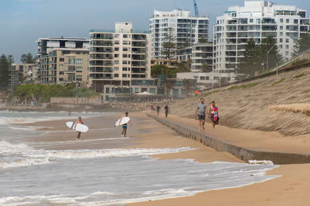 Sydney, Australia 2020-02-15 People walking on concrete basement exposed at North Cronulla after the storm which sucked thousand of tonnes of sand into the oceanのeditorial素材