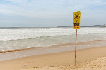Dangerous current sign for swimmers at the beach in Australiaの写真素材